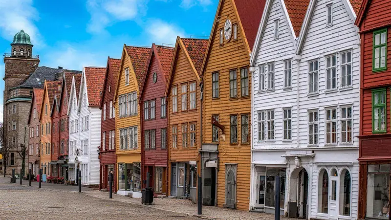 The row of colourful wooden Bryggen merchant houses along the empty harbour square in Bergen