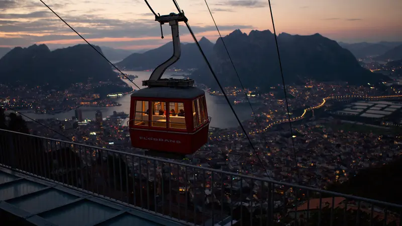 Fløibanen funicular carriage climbing above Bergen rooftops at dusk