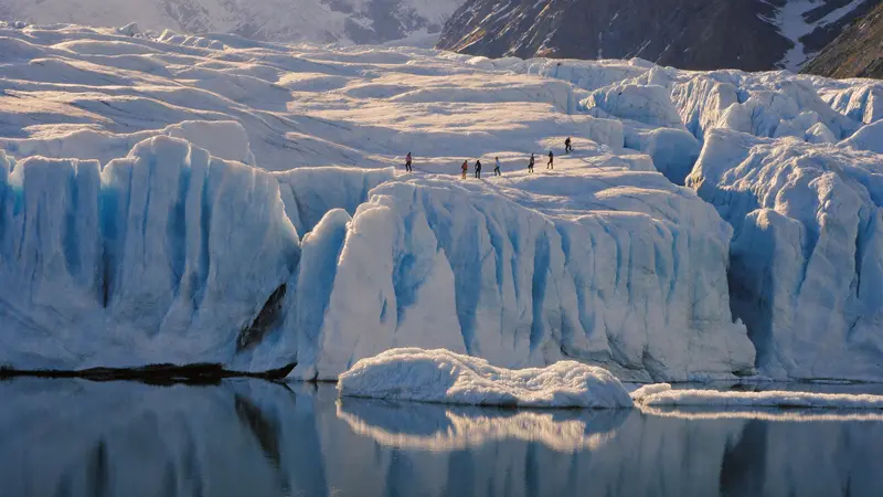 Roped hikers in crampons on the blue ice of a Jostedalsbreen glacier arm