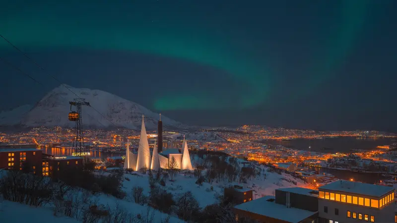 Tromsø and the Arctic Cathedral under a faint aurora at polar-night blue hour